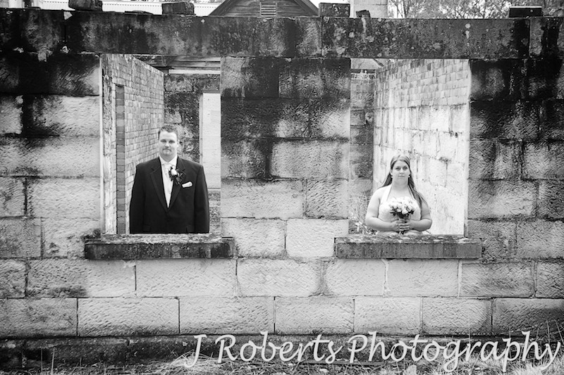 B&W of bride and groom looking through windows - wedding photography sydney